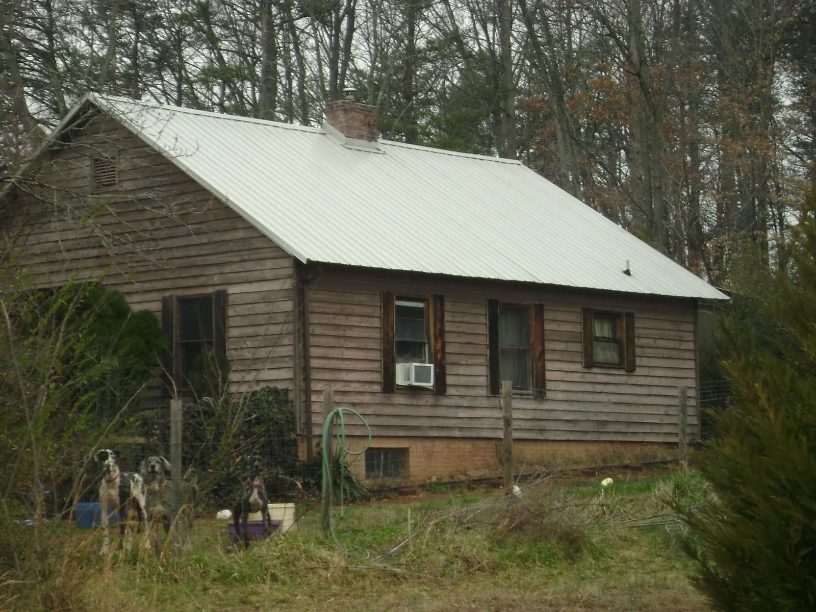 White metal roof on an old wood sided farmhouse, from a Metal Roof Installation job in Oakesdale